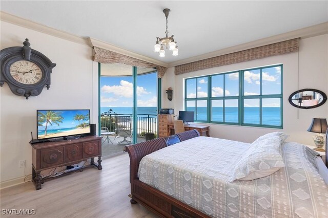 bedroom featuring light wood-type flooring, access to outside, ornamental molding, and a notable chandelier