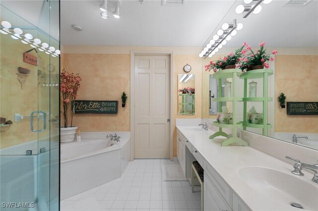 bathroom featuring tile patterned floors, vanity, and shower with separate bathtub