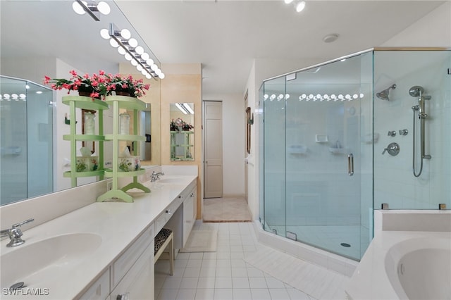 bathroom featuring tile patterned floors, vanity, and shower with separate bathtub