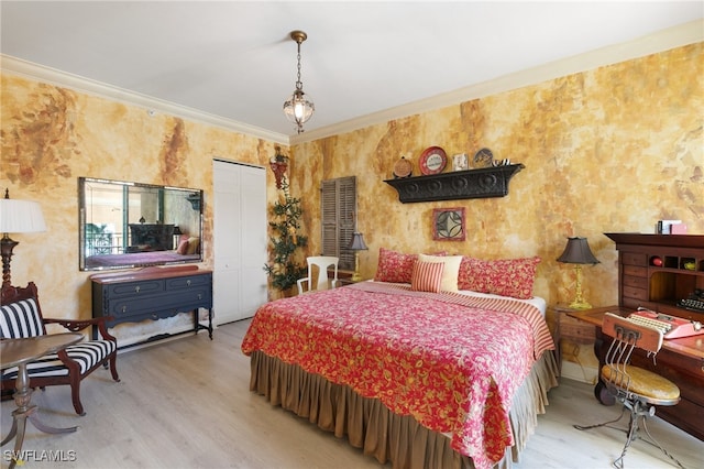 bedroom with light hardwood / wood-style floors, a closet, and ornamental molding