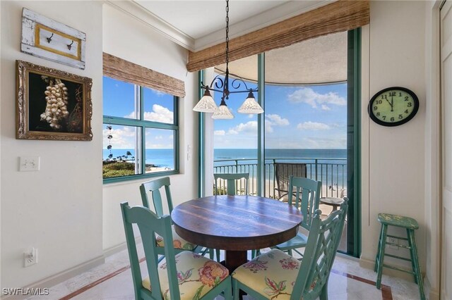 dining room with a water view and ornamental molding