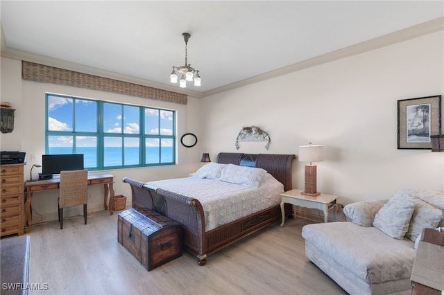 bedroom featuring crown molding, light hardwood / wood-style flooring, and an inviting chandelier