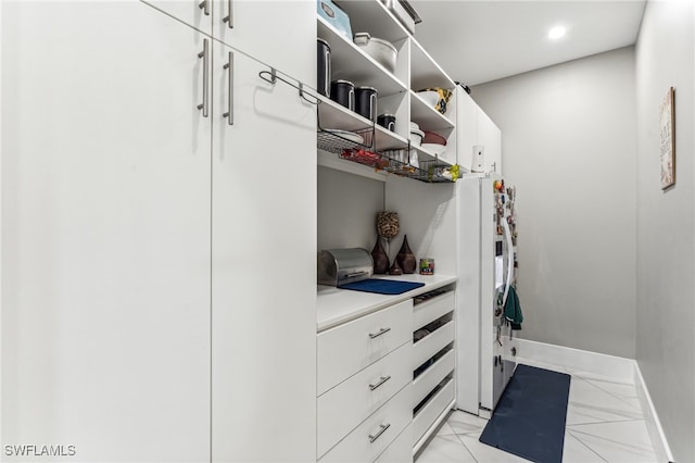 spacious closet featuring light tile patterned floors