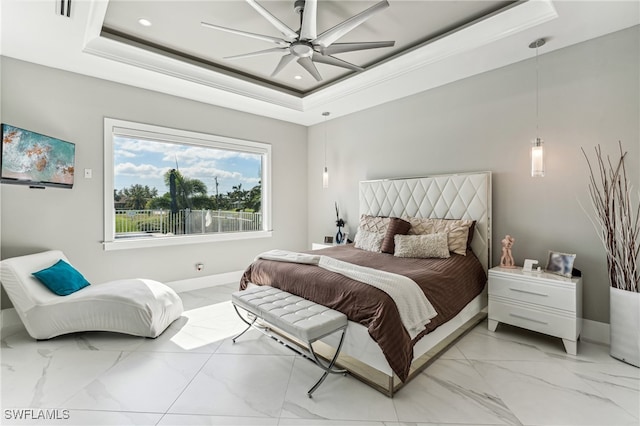 bedroom with a tray ceiling and ceiling fan