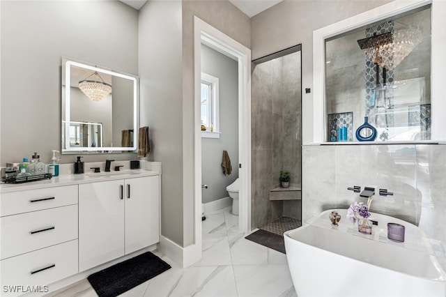 bathroom with vanity, a bath, a notable chandelier, and toilet