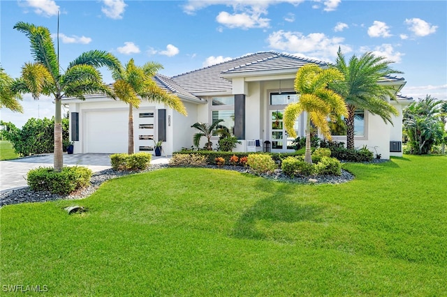 view of front of house featuring a front lawn and a garage