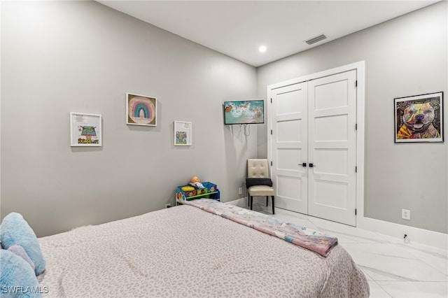 tiled bedroom with a closet