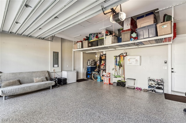 garage featuring electric panel and a garage door opener