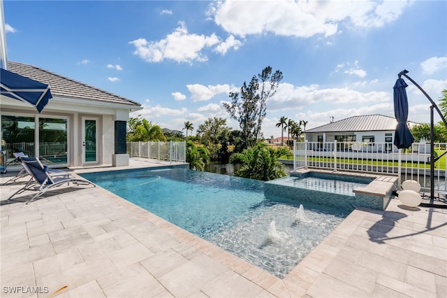 view of pool with an in ground hot tub, pool water feature, and a patio