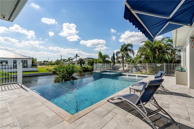 view of swimming pool featuring a patio area and an in ground hot tub