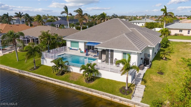 exterior space featuring a lawn, a water view, and a patio