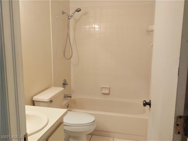 full bathroom with tiled shower / bath, tile patterned flooring, vanity, and toilet