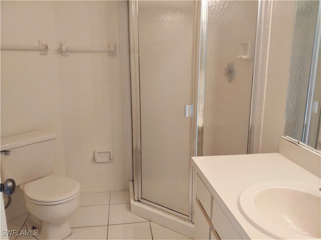 bathroom with tile patterned floors, toilet, an enclosed shower, and vanity