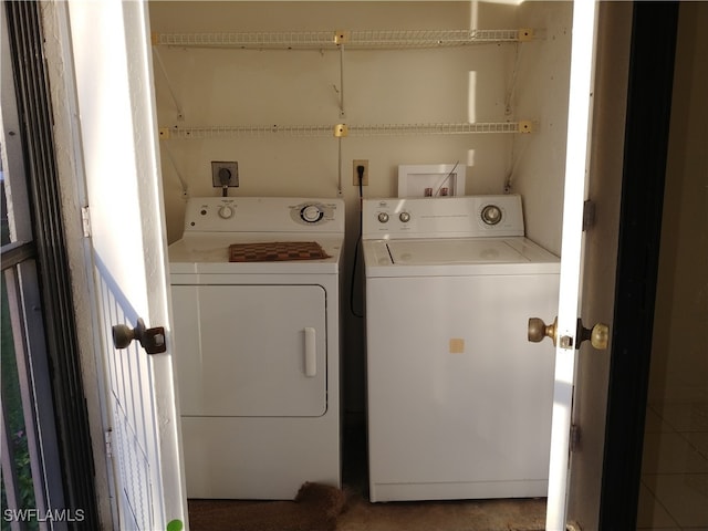 clothes washing area with washing machine and dryer