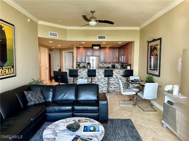 living room with ceiling fan, light tile patterned flooring, and ornamental molding