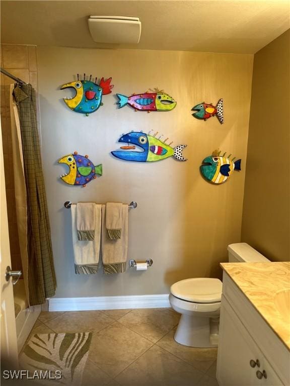 bathroom with tile patterned flooring, vanity, and toilet