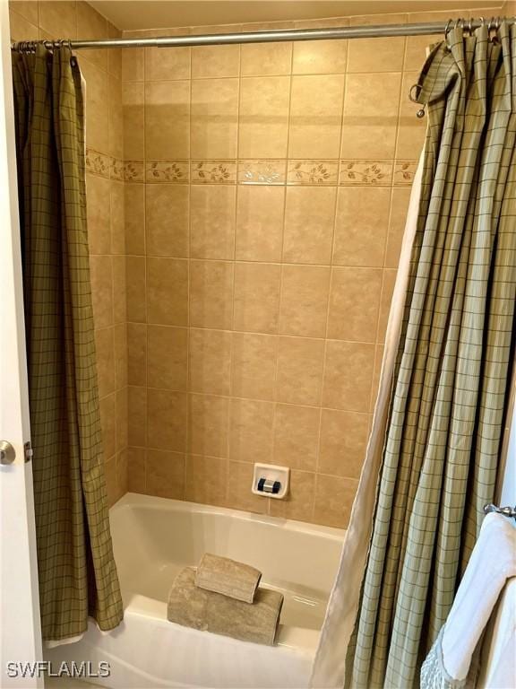 bathroom with shower / bathtub combination with curtain