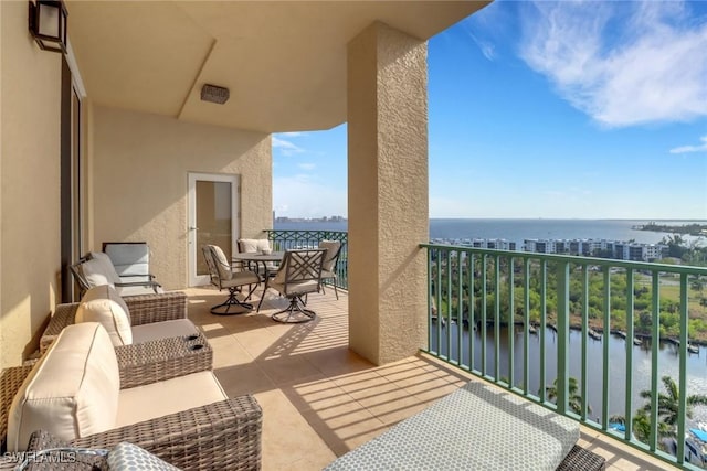 balcony featuring a water view and an outdoor hangout area