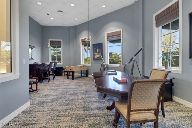 carpeted office with a drop ceiling, baseboards, a high ceiling, and visible vents