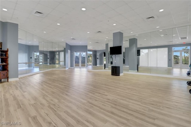 exercise area featuring visible vents, baseboards, and light wood-style floors