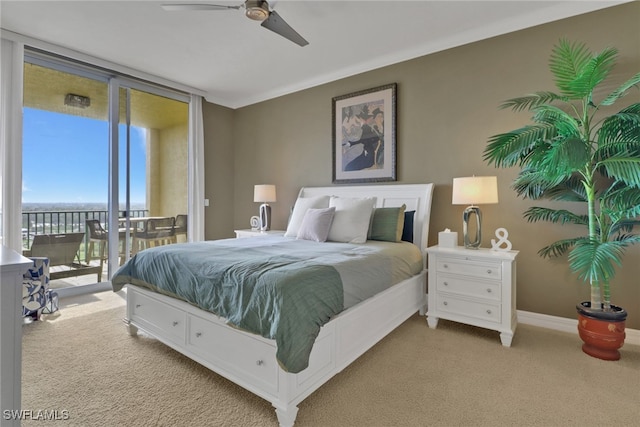 bedroom with a ceiling fan, expansive windows, carpet flooring, baseboards, and access to exterior