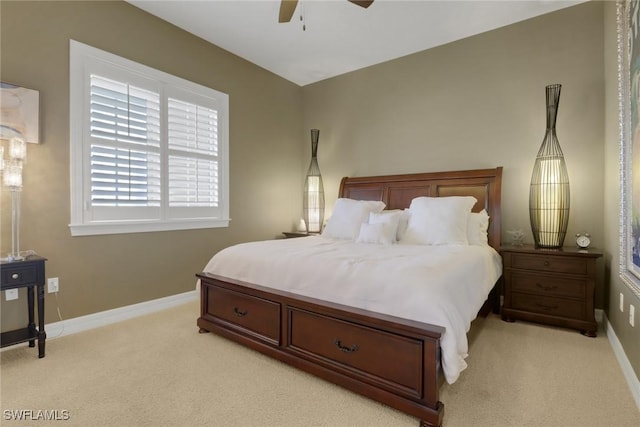 bedroom with baseboards, light colored carpet, and a ceiling fan