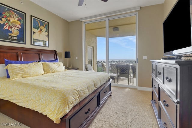 bedroom featuring baseboards, ceiling fan, access to exterior, expansive windows, and light carpet