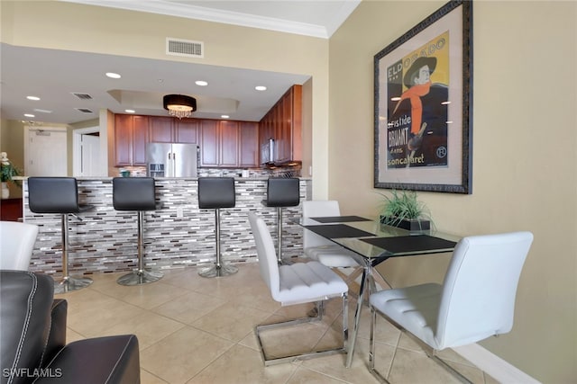 dining room with light tile patterned floors, visible vents, recessed lighting, and ornamental molding