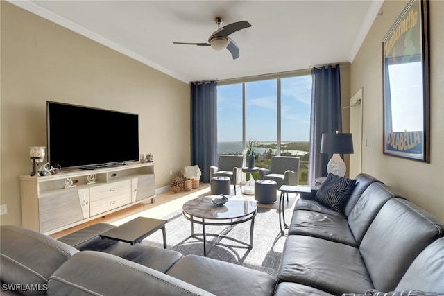 living area with floor to ceiling windows, a ceiling fan, baseboards, and ornamental molding