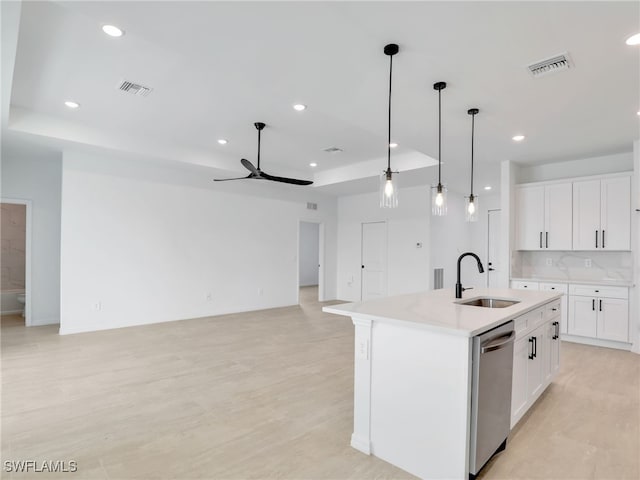 kitchen with a kitchen island with sink, sink, pendant lighting, dishwasher, and white cabinetry