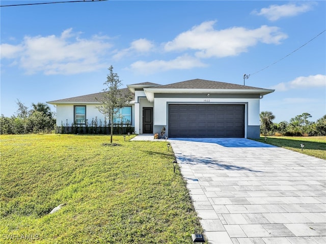 view of front of house with a garage and a front lawn