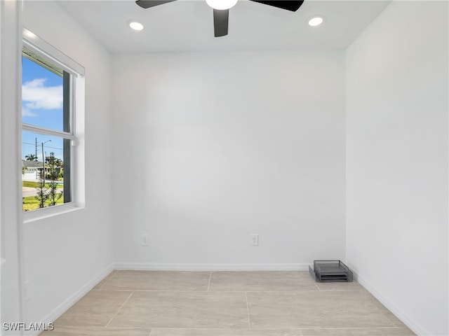 spare room with ceiling fan, light tile patterned floors, and a wealth of natural light