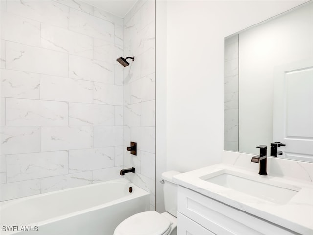 full bathroom with toilet, vanity, and tiled shower / bath