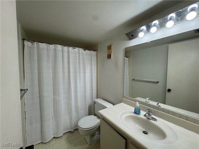 bathroom with toilet, a textured ceiling, vanity, and tile patterned floors