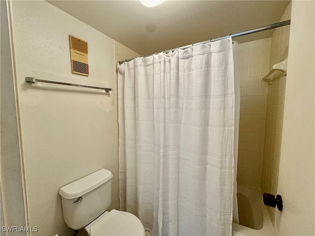 bathroom with toilet and walk in shower