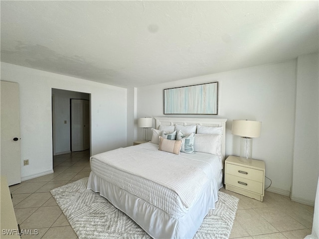 bedroom with light tile patterned floors