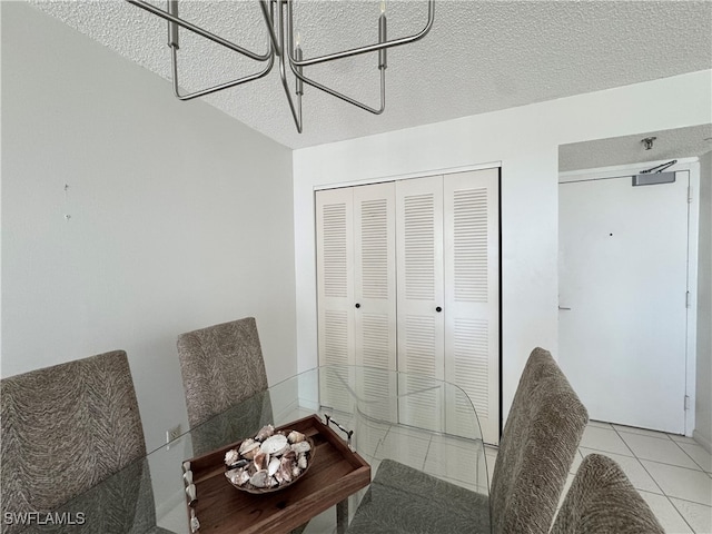 dining room with light tile patterned floors and a textured ceiling