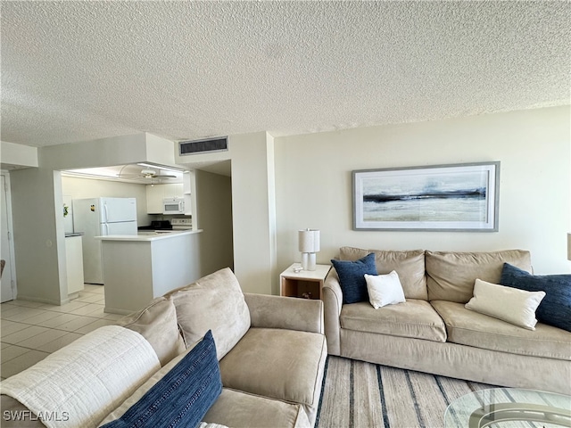 living room with light tile patterned floors and a textured ceiling