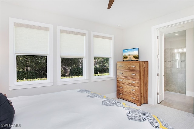 bedroom featuring ensuite bath and ceiling fan