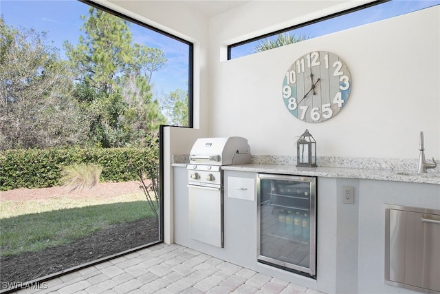 view of patio featuring sink, exterior kitchen, grilling area, and wine cooler