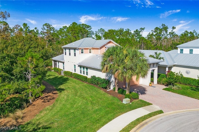 view of front facade with a garage and a front lawn