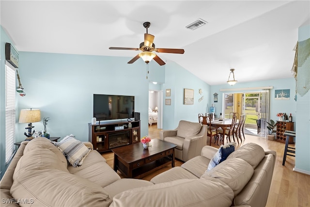 living room with light hardwood / wood-style flooring, ceiling fan, and lofted ceiling