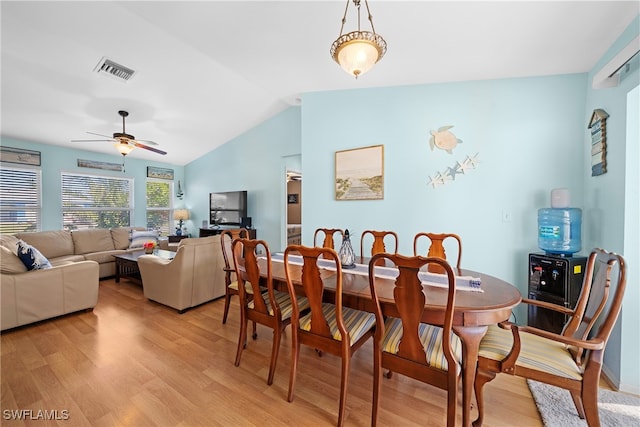 dining room featuring ceiling fan, light hardwood / wood-style floors, and lofted ceiling