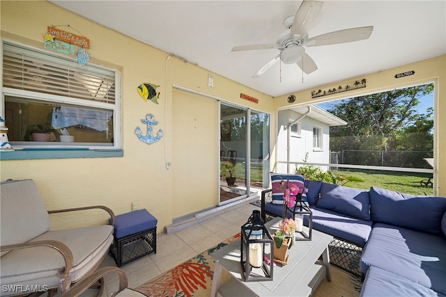 sunroom / solarium featuring ceiling fan