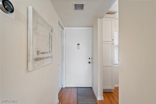 corridor with light hardwood / wood-style floors