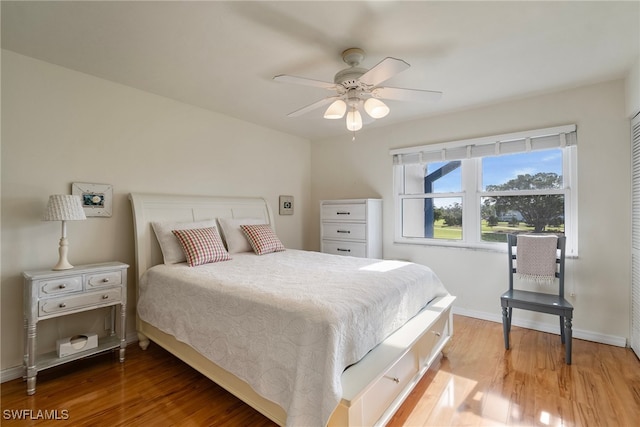 bedroom with hardwood / wood-style floors and ceiling fan