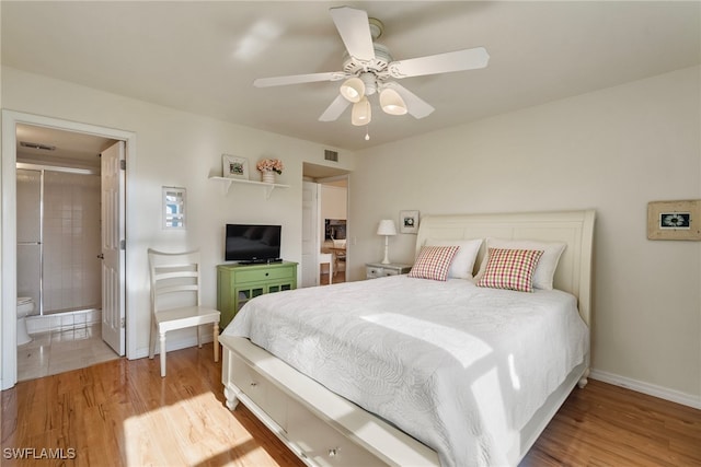 bedroom with ceiling fan, ensuite bath, and light hardwood / wood-style flooring