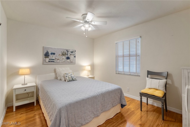 bedroom with wood-type flooring and ceiling fan