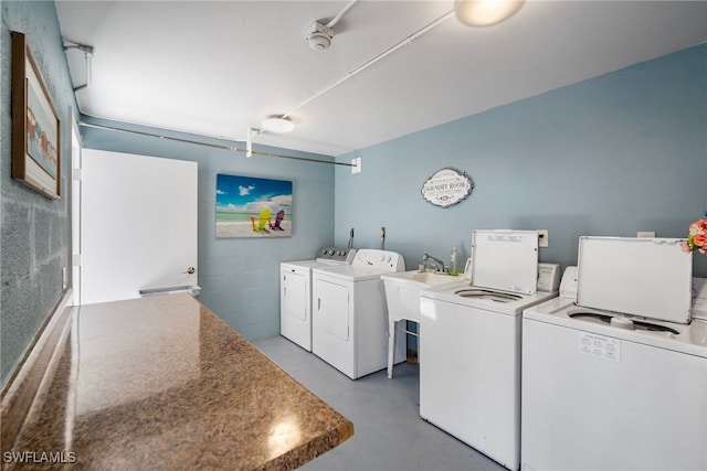 laundry area with washing machine and dryer and sink