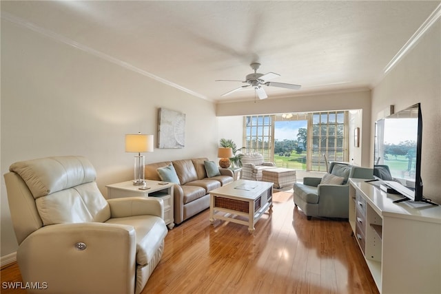 living room featuring ceiling fan, light wood-type flooring, and ornamental molding